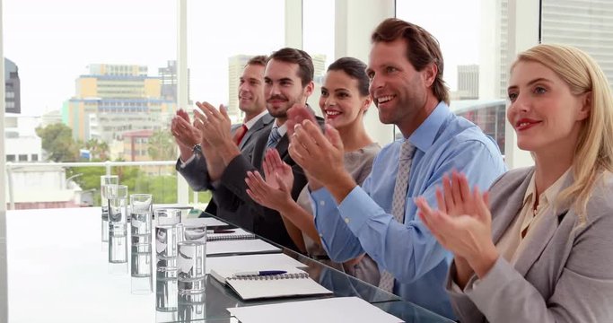 Interview panel applauding the applicant in the office