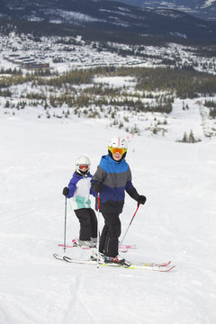 Norway, Hedmark, Trysil, Two children (10-11, 12-13) skiing in mountains