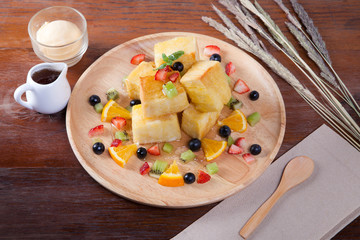 Close up of dessert which has Bread, strawberry berries, blueber