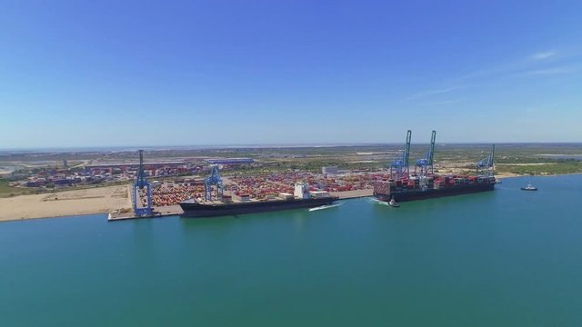 AERIAL: Loading big container ships with cargo at shipping port