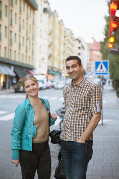 Sweden, Stockholm, Skanegatan, Sodermalm, Portrait of smiling couple standing on street