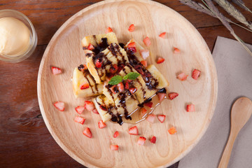 Close up of dessert which has Bread, strawberry berries, caramel