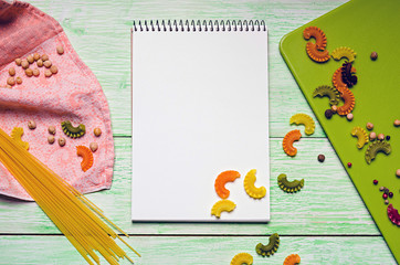 notebook with noodles on wooden