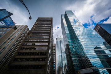 Fototapeta premium Dramatic sky and modern buildings in the Financial District, in