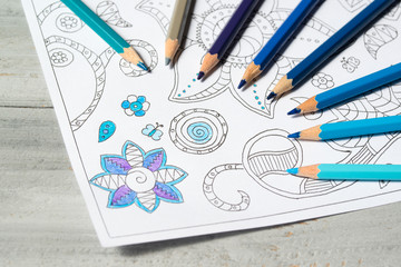 Coloring book for adults with blue colored pencils, antistress painting