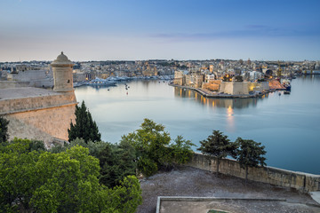 Fototapeta na wymiar Valletta, Malta - Early morning skyline view of the Grand Harbour of Malta with watch tower and Senglea at the background