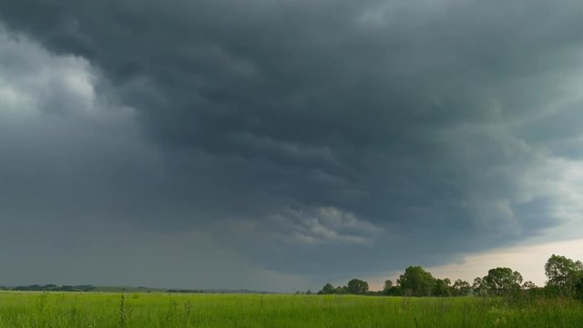 dark storm clouds are moving over countryside field, 4k
