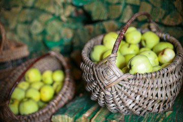 Wicker baskets full of fresh green apples