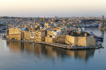 Skyline view of Malta with Senglea and Gardjola Gardens at sunset