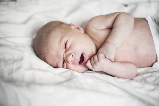 Sweden, Newborn baby boy (0-1 months) lying on bed