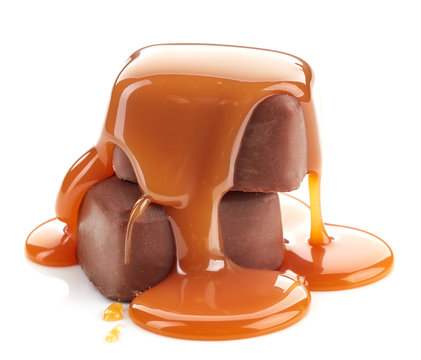 caramel sauce pouring on chocolate candies
