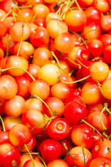 Ripe colored sweet cherries in the market on the counter