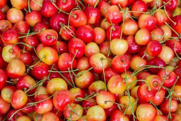 Ripe colored sweet cherries in the market on the counter