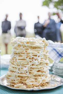 Sweden, Skane, Close up of Spettekaka cake, people in background