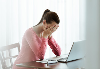 Tired and stressed woman on her computer. 