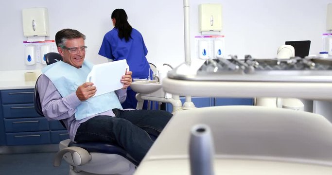 Patient admiring his new smile in the mirror