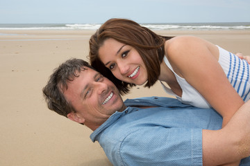 Happy honeymooners enjoying their vacation on beach