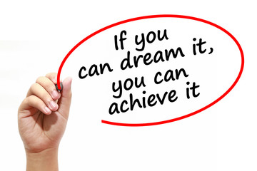 Man writing If you can dream it,you can achieve it with marker on transparent wipe board.