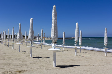 Closed parasols on the beach