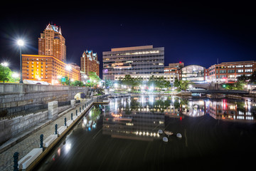 Modern buildings and the Providence River at night, in downtown