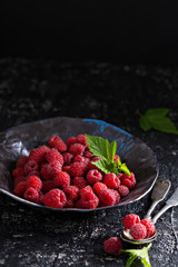 Fresh sweet raspberry in black bowl