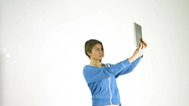 Pretty girl taking selfie with tablet pc in ultra hd format