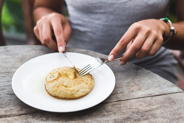 Breakfast with banana pancake topped with honey