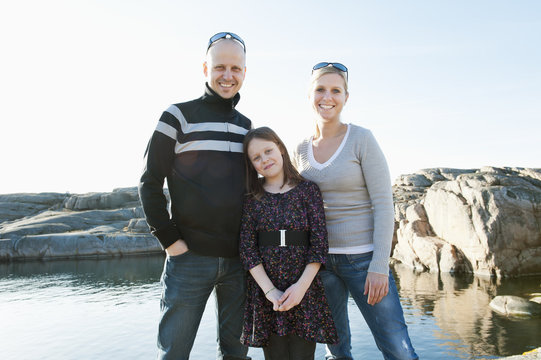 Portrait of smiling family standing outdoors