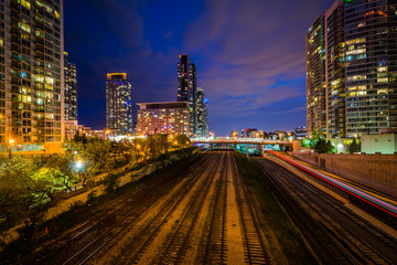 Railroad tracks and modern buildings at night, in downtown Toron