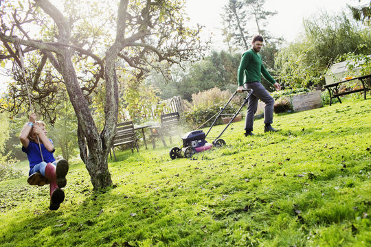 Sweden, Skane, Osterlen, Borrby, Father and son (4-5) in domestic garden 
