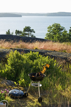 Sweden, Sodermanland, Stockholm Archipelago, Haninge, Dalaro, Barbecue grill on grassy hill