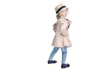 Fashionable child. Blonde girl in a stylish raincoat and hat.