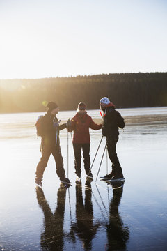 Sweden, Gastrikland, Edsken, Mature People Ice Skating On Frozen Lake