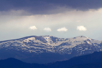 Naklejka na ściany i meble Mountain snow peak in carpathian with dramatic sky