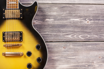 Electric guitar on wooden planks