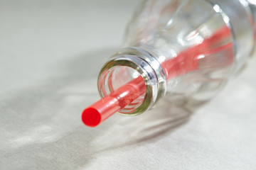 Empty soda bottle and straw