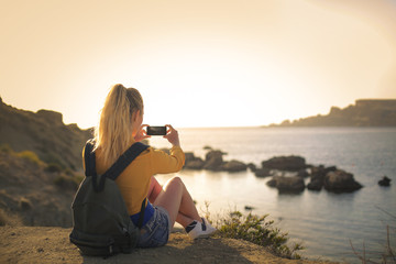 Girl taking a picture of the landscape