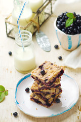 Blueberry cake and bottle of milk .