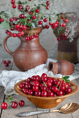 Berries, cherries in a bowl and bouquet