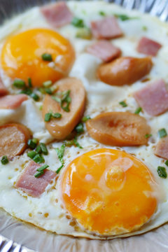 pan egg with ham and sausages