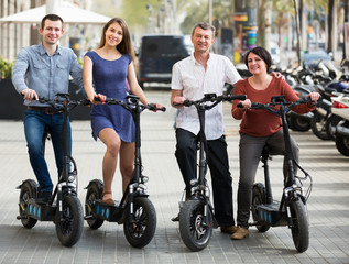 Fototapeta na wymiar Positive family of four with electrkc bikes
