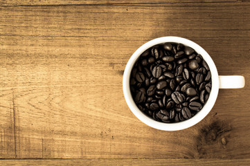 Black coffee in white cup on wood background