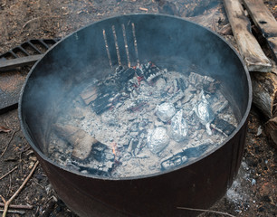 Baked potatoes in camp fire pit