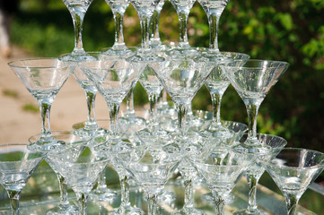 Pyramid of glasses of champagne. hill.