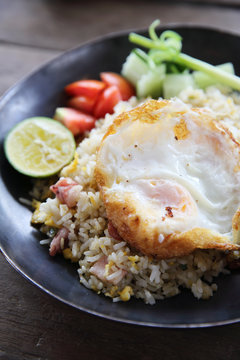 fried pork bacon rice with Poached egg on wood background Thai f