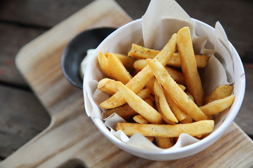 Fried potatoes french fries on wooden background