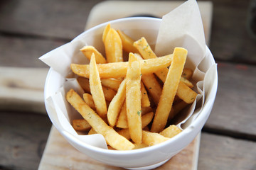 Fried potatoes french fries on wooden background