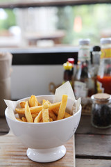 Fried potatoes french fries on wooden background