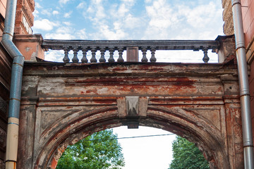 Old classic arch with balustrade against the sky summer evening