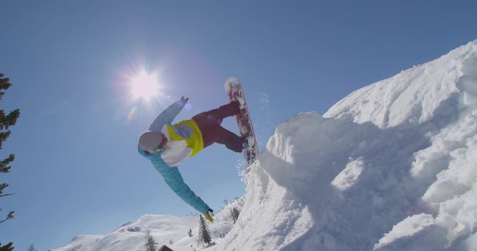 SLOW MOTION: Snowboarder does handplant trick